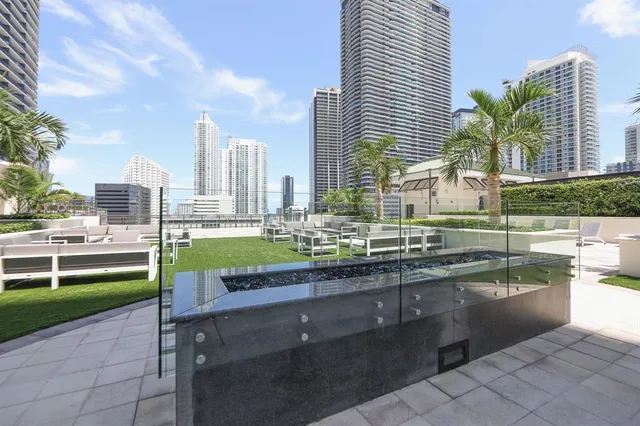 a swimming pool with outdoor seating and yard