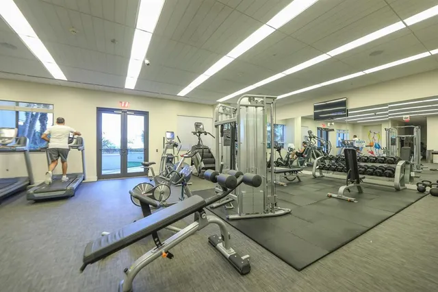 a room with gym equipment and floor to ceiling window