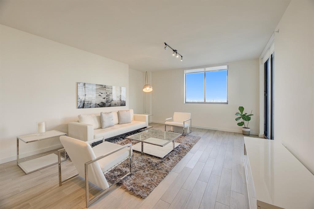 999 Southwest 1st Avenue, Unit 2913 Miami, FL 33130 - Photo 7 of 36 a living room with furniture and a wooden floor