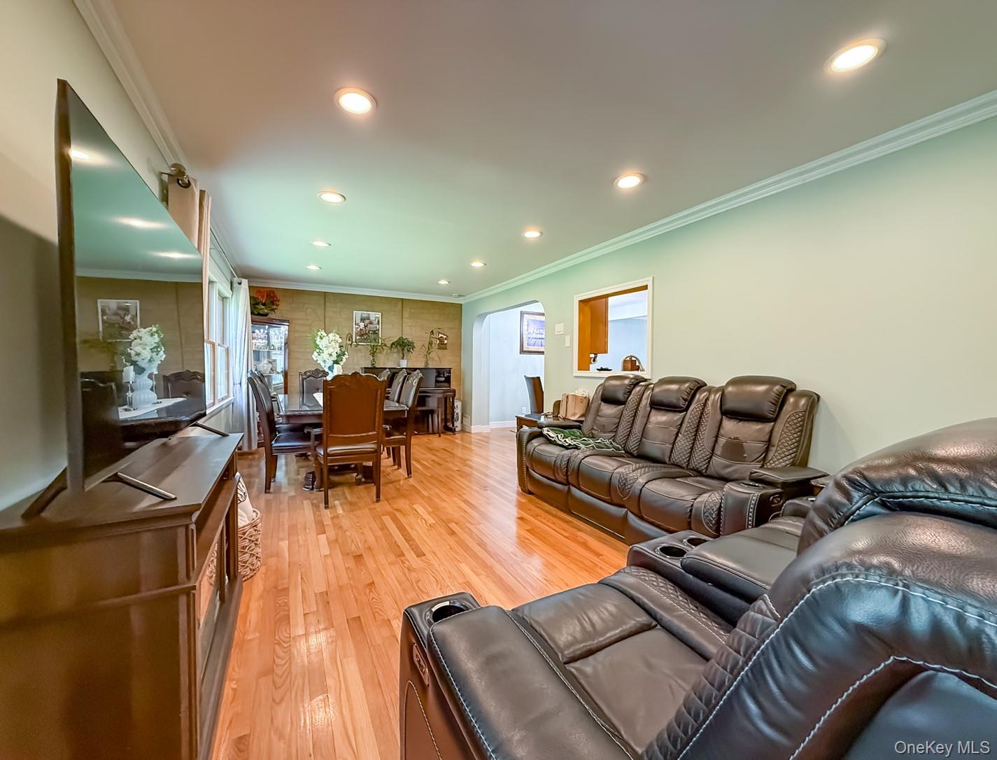 49 Meadow Road Montrose, NY 10548 - Photo 14 of 50 Hardwood flooring extends throughout the expansive room, featuring recessed lighting and crown molding