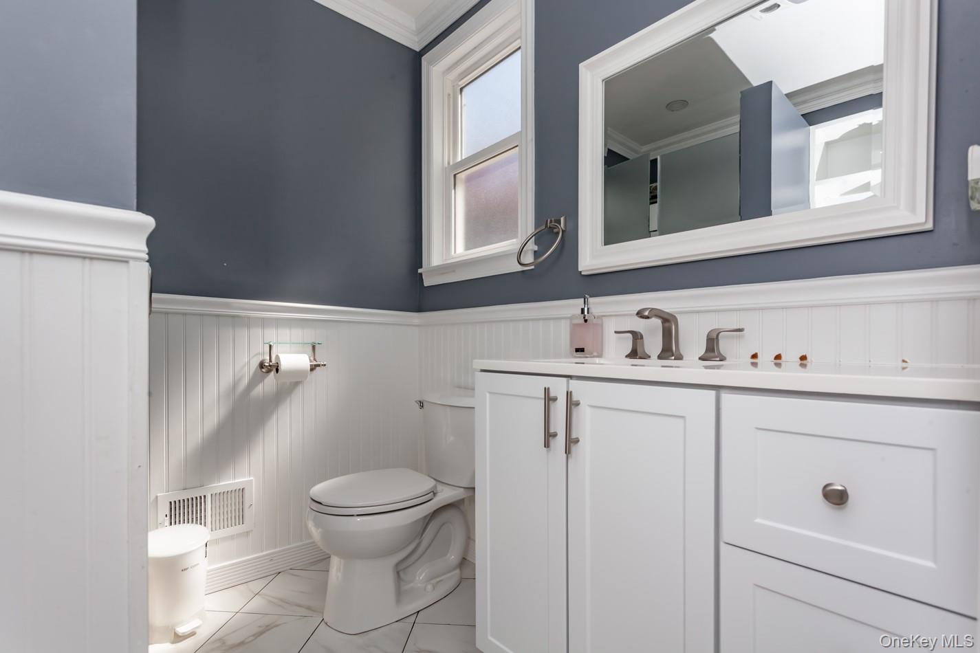 49 Meadow Road Montrose, NY 10548 - Photo 15 of 50 First floor.White vanity with brushed nickel hardware, white countertop, and brushed nickel faucet