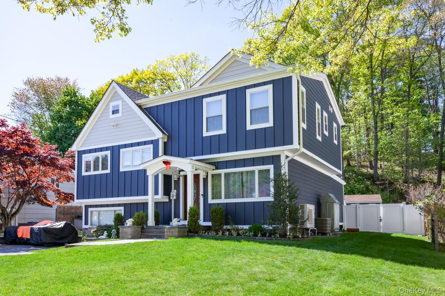 49 Meadow Road Montrose, NY 10548 - Photo 2 of 50 Two-story residence featuring blue vertical siding with light gray gable accents