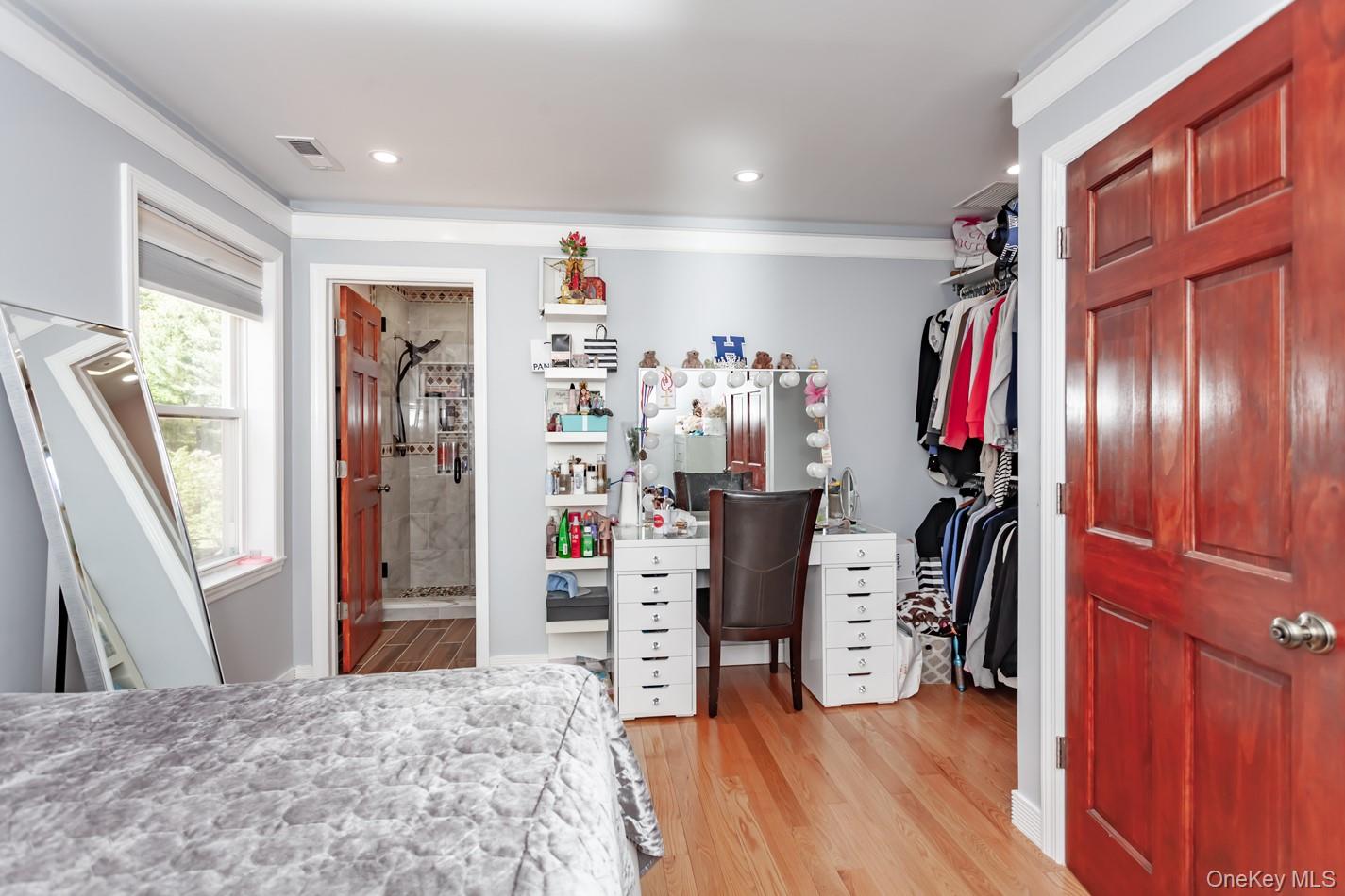 49 Meadow Road Montrose, NY 10548 - Photo 26 of 50 Hardwood flooring throughout featuring an open closet with built-in shelving, recessed lighting, and crown molding