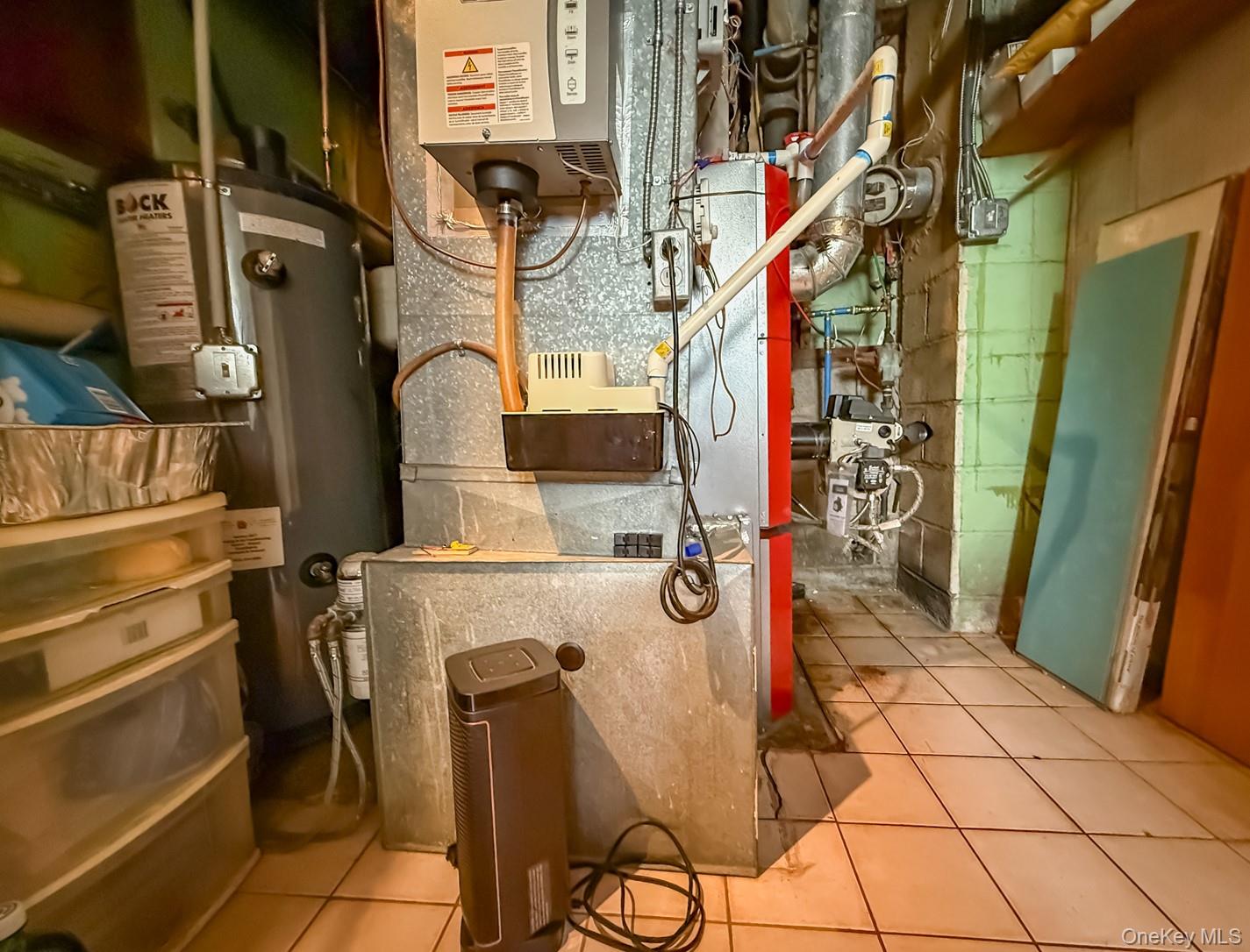 49 Meadow Road Montrose, NY 10548 - Photo 37 of 50 Utility room featuring a water heater, furnace, and tiled flooring