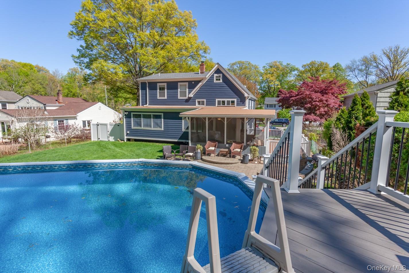 49 Meadow Road Montrose, NY 10548 - Photo 42 of 50 Above-ground swimming pool with a dark blue liner, complemented by a screened-in porch with an attached patio area