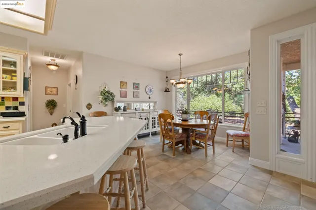 a dining room with furniture and a large window