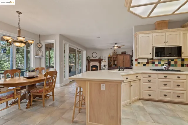 a kitchen with stainless steel appliances a stove a table and chairs