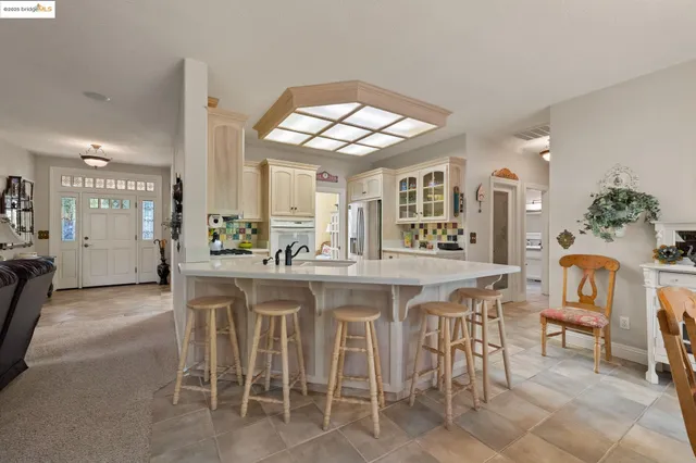 a kitchen with a dining table chairs and large window