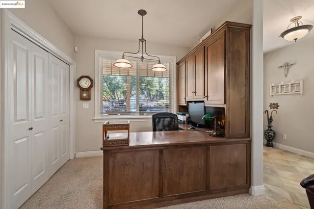a kitchen with kitchen island granite countertop a sink cabinets and window