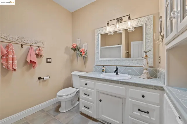 a bathroom with a granite countertop sink toilet a large mirror and shower