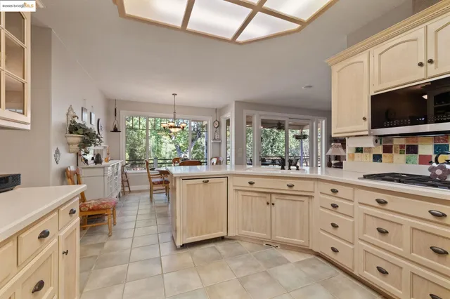a kitchen with white cabinets and sink