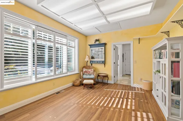 a spacious bedroom with a large window and bed