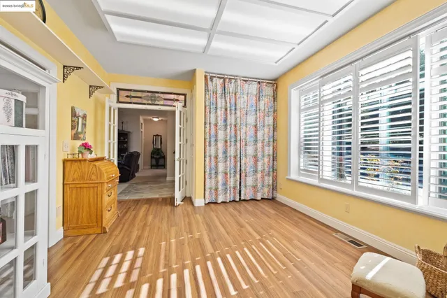 a view of a room with wooden floor and furniture