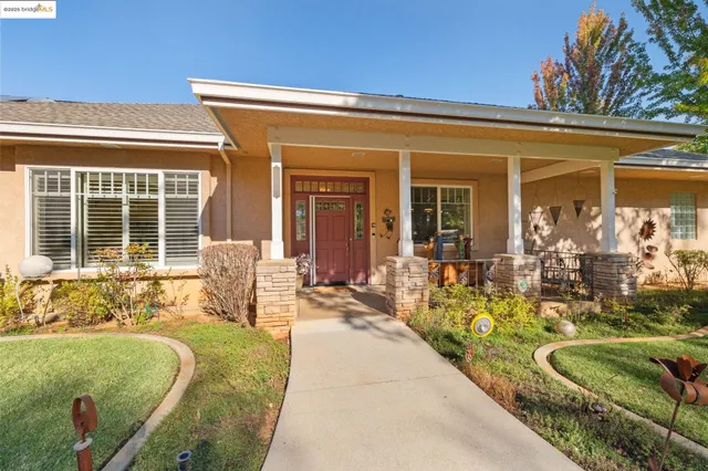 a front view of a house with outdoor seating
