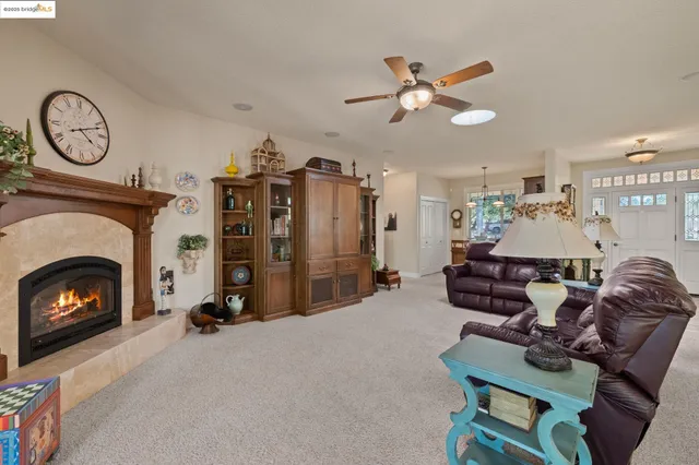 a living room with furniture a fireplace and a clock