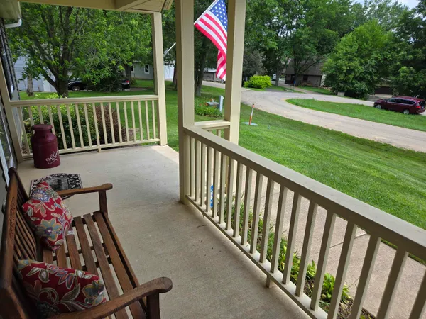 a view of wooden deck and a yard with wooden fence