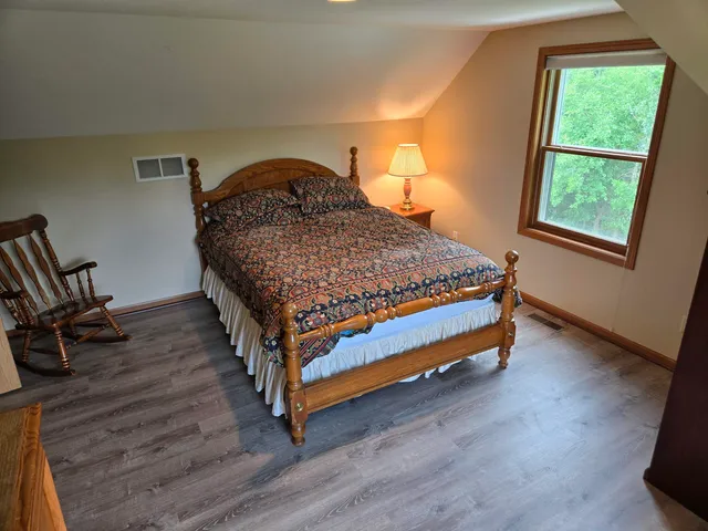 a bed sitting in a bedroom next to a window