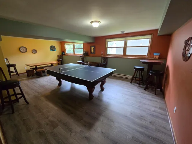 a room with furniture pool table and windows