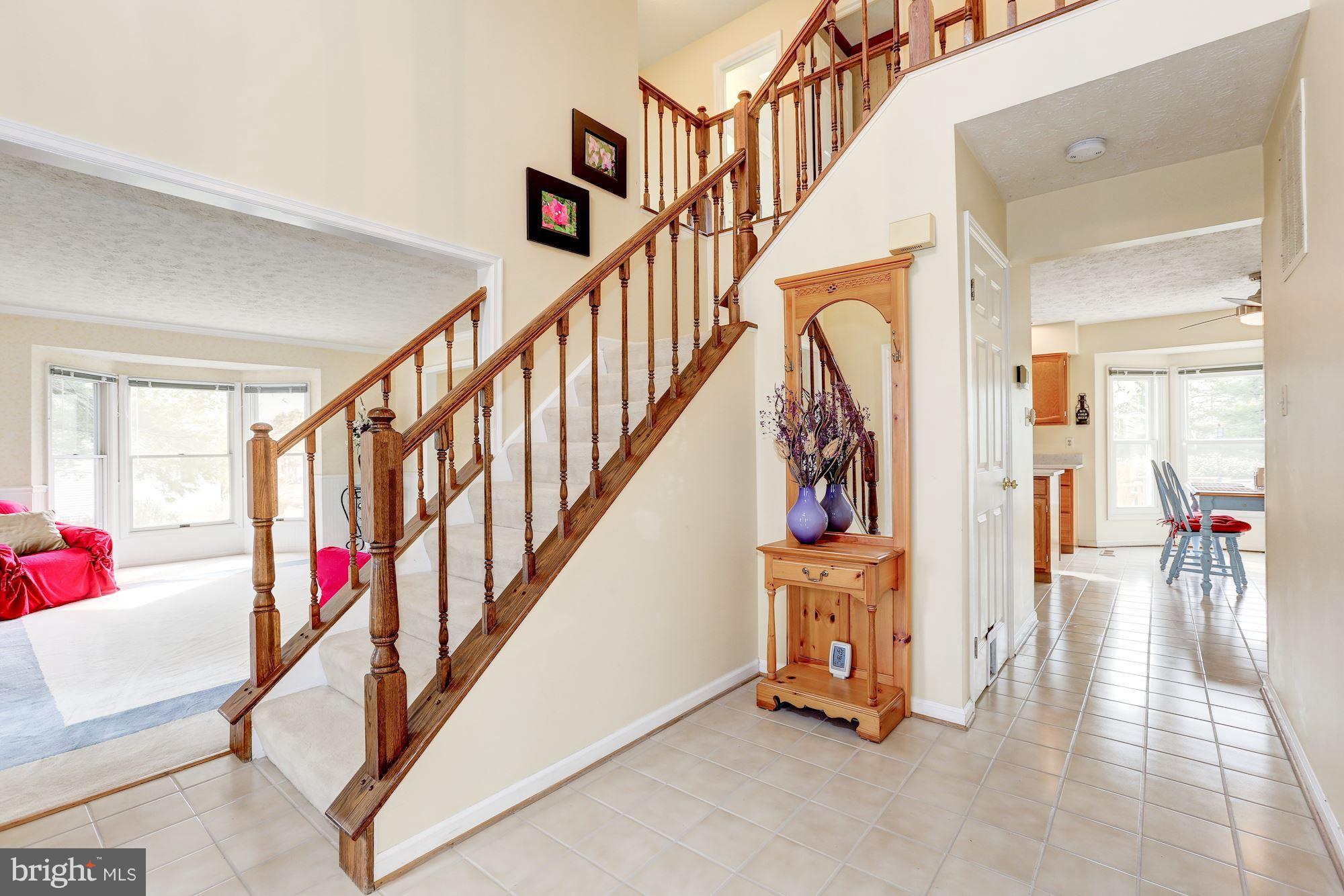 17005 Spates Hill Road Poolesville, MD 20837 - Photo 11 of 25 a view of an entryway with wooden floor and stairs