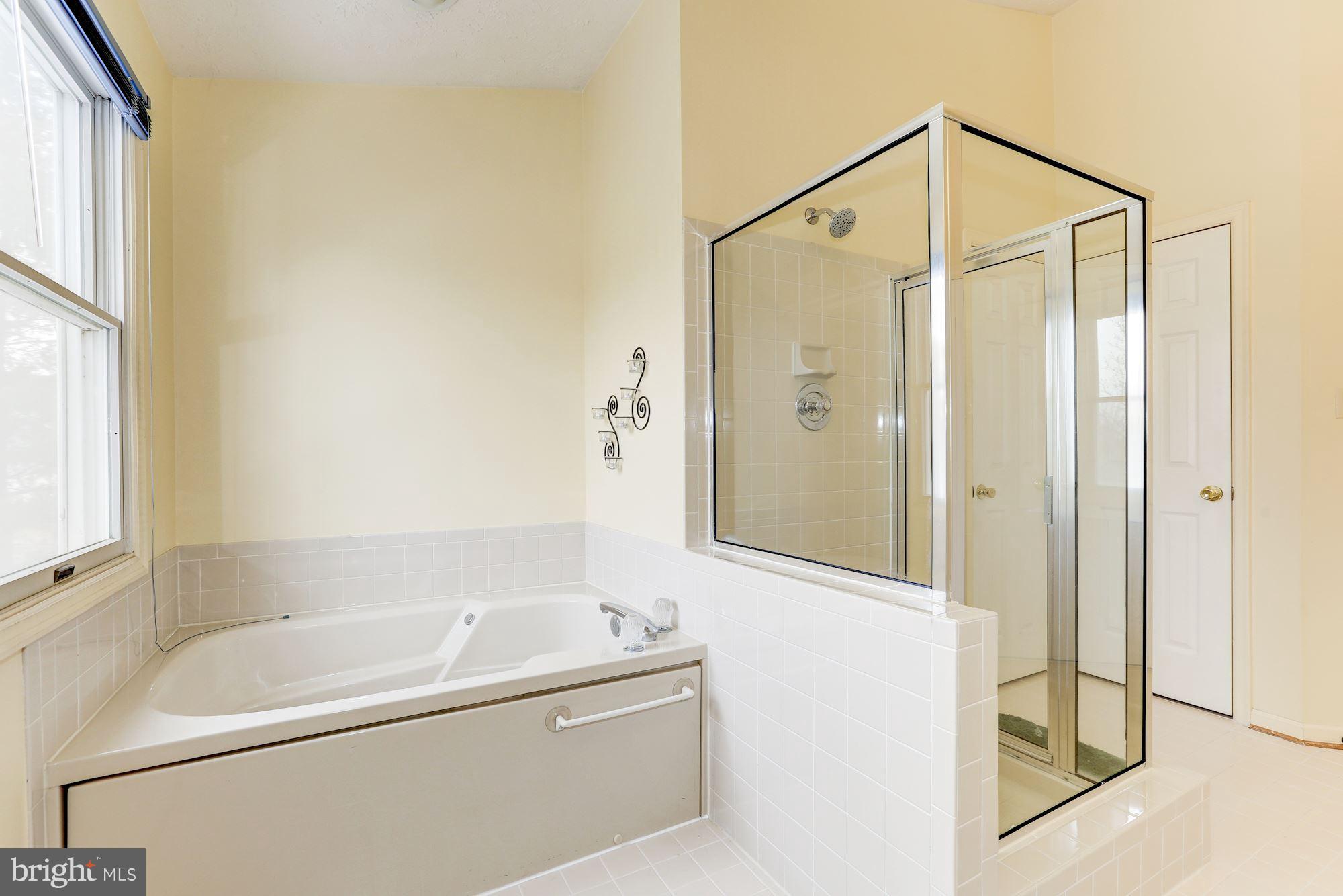 17005 Spates Hill Road Poolesville, MD 20837 - Photo 14 of 25 a bathroom with a bathtub and a shower