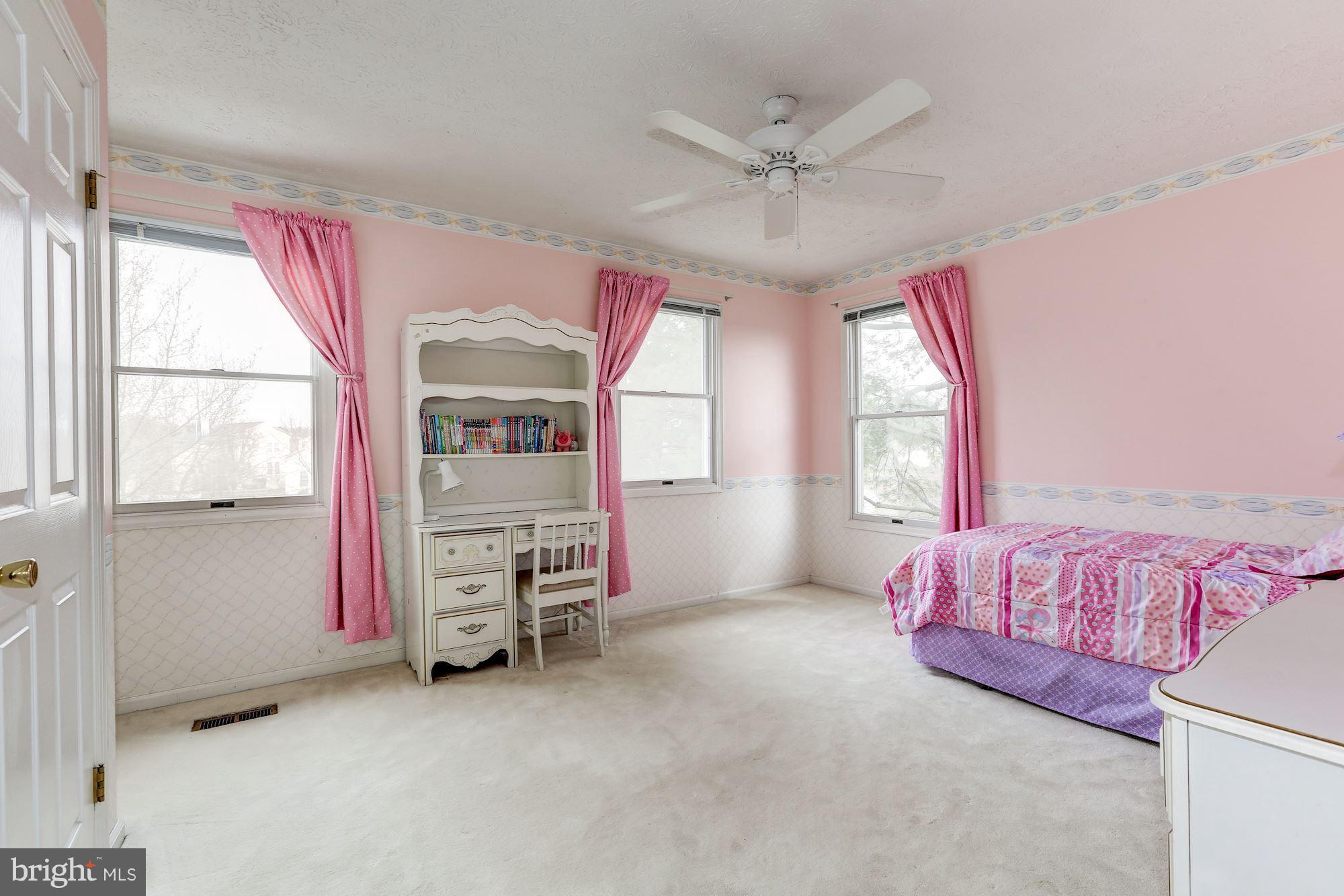 17005 Spates Hill Road Poolesville, MD 20837 - Photo 15 of 25 a bedroom with a bed and a chandelier