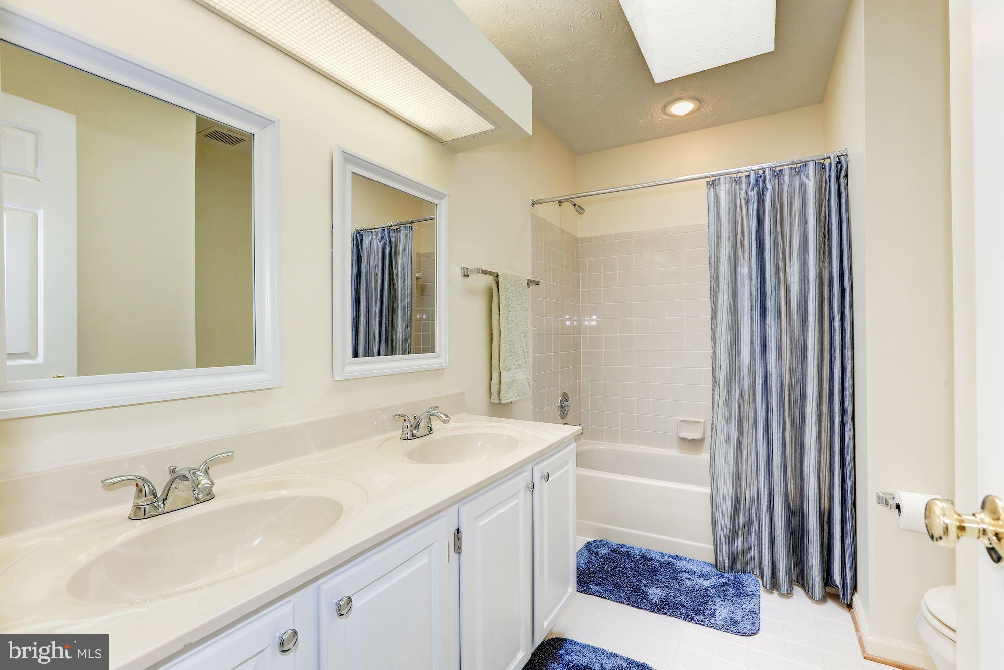 17005 Spates Hill Road Poolesville, MD 20837 - Photo 18 of 25 a bathroom with a sink a toilet and shower