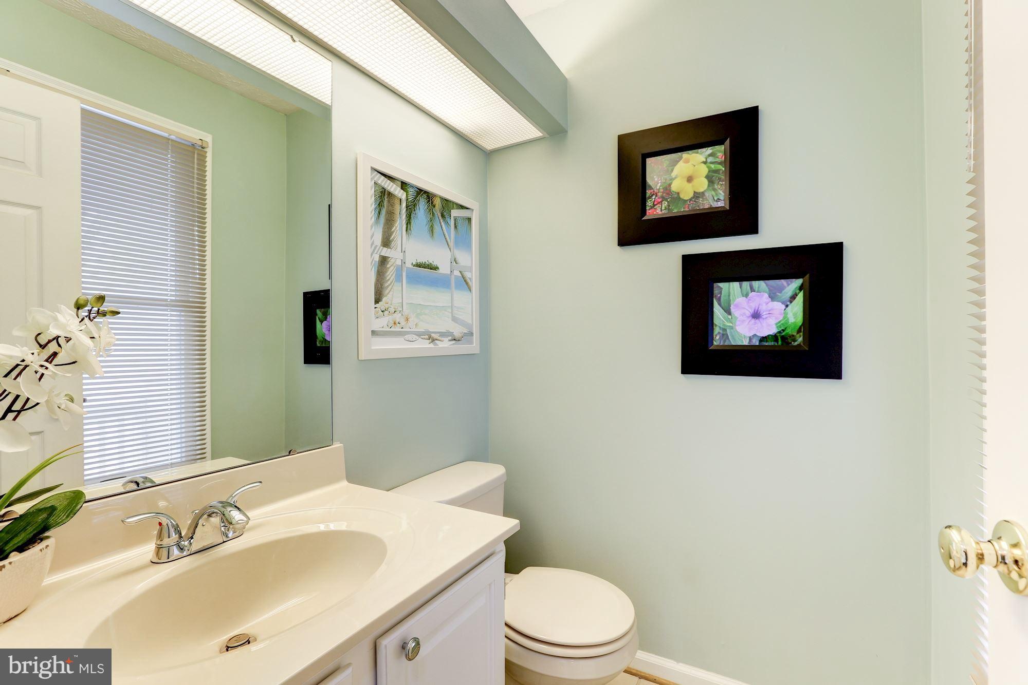 17005 Spates Hill Road Poolesville, MD 20837 - Photo 19 of 25 a bathroom with a toilet sink and mirror