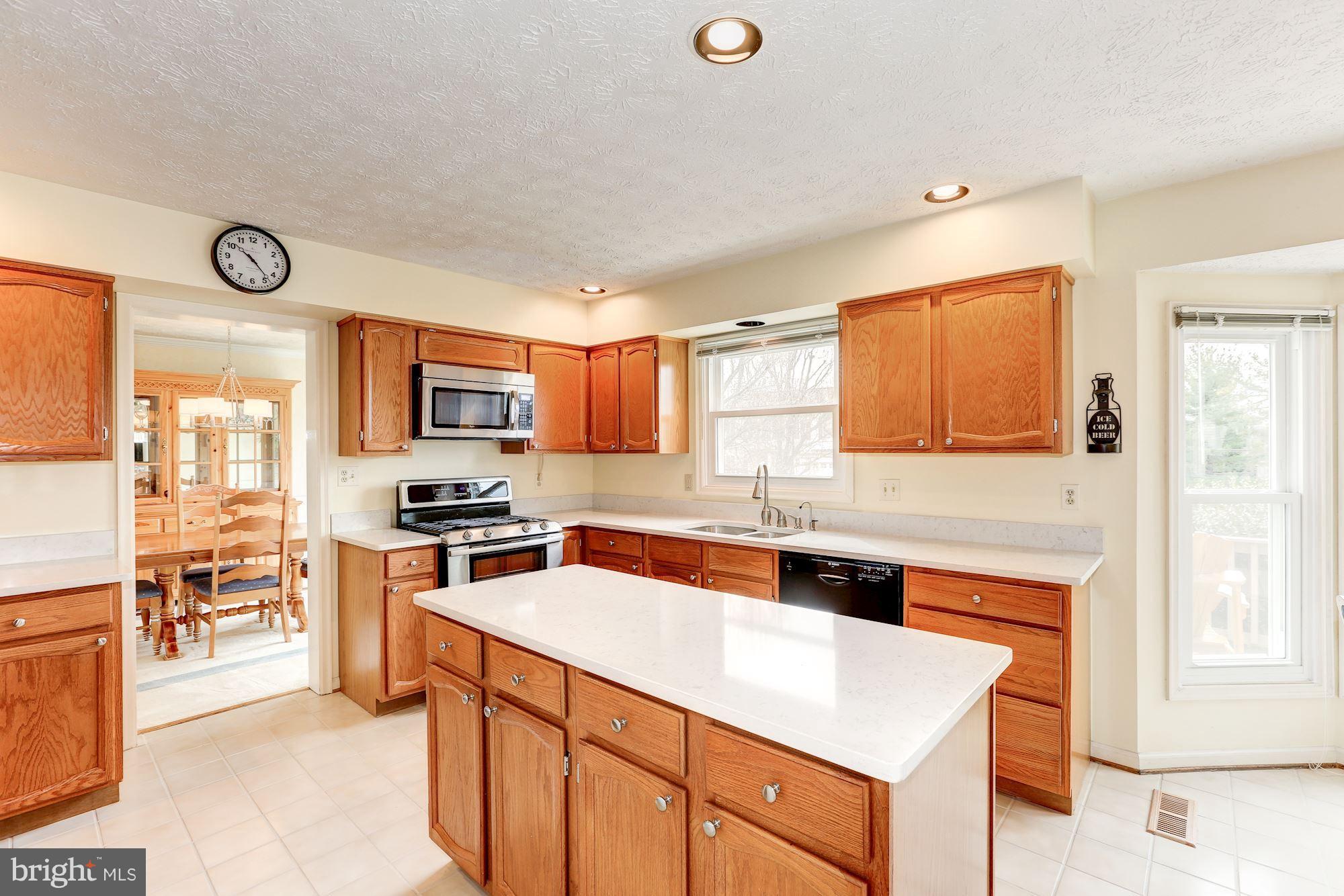 17005 Spates Hill Road Poolesville, MD 20837 - Photo 4 of 25 a kitchen with a sink a stove top oven a counter space and cabinets