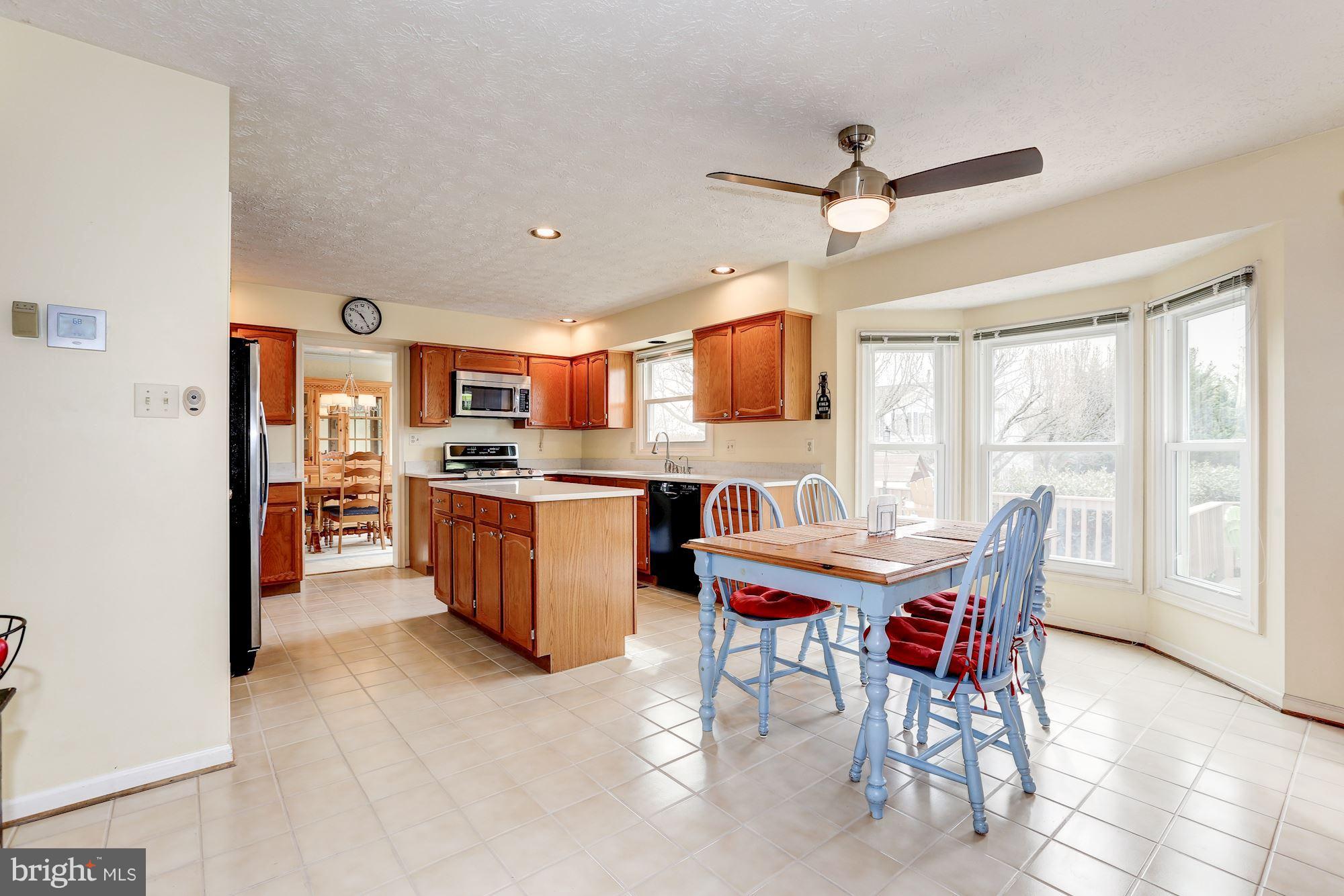 17005 Spates Hill Road Poolesville, MD 20837 - Photo 6 of 25 a view of a dining room with furniture window and wooden floor