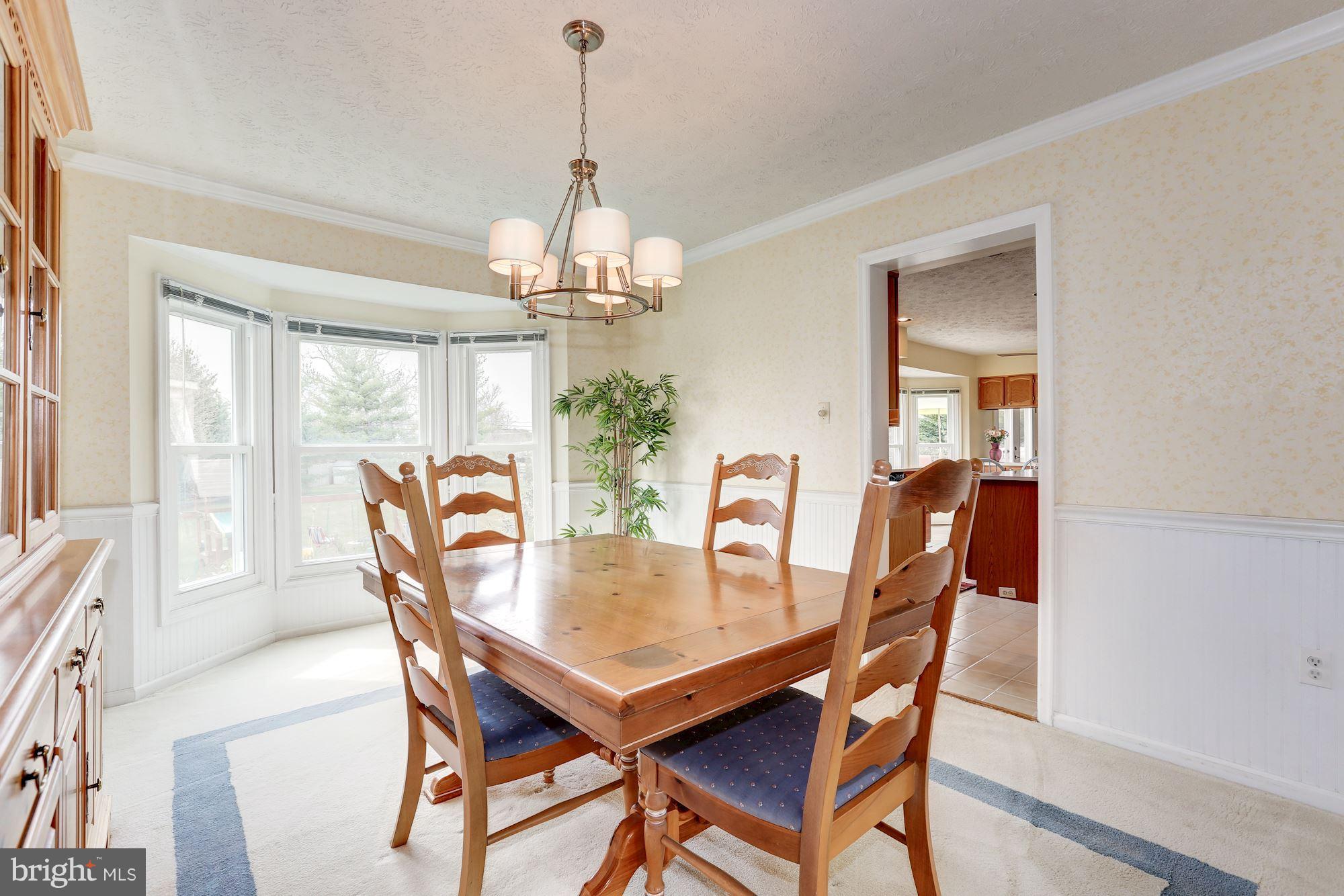 17005 Spates Hill Road Poolesville, MD 20837 - Photo 9 of 25 a view of a dining room with furniture a chandelier and wooden floor