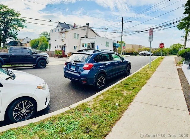 a view of a cars park in front of a house