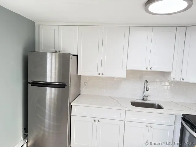 a white refrigerator freezer sitting in a kitchen