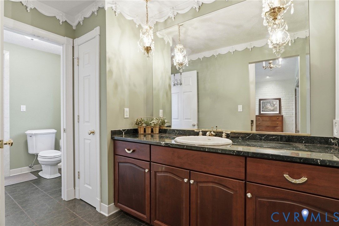 13300 West Patrick Henry Road Doswell, VA 23047 - Photo 25 of 69 Expansive vanity featuring a dark wood-finish cabi