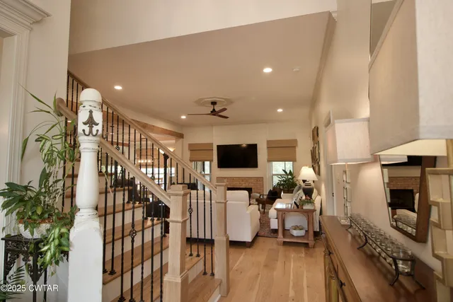 a living room with furniture ceiling fan and a rug