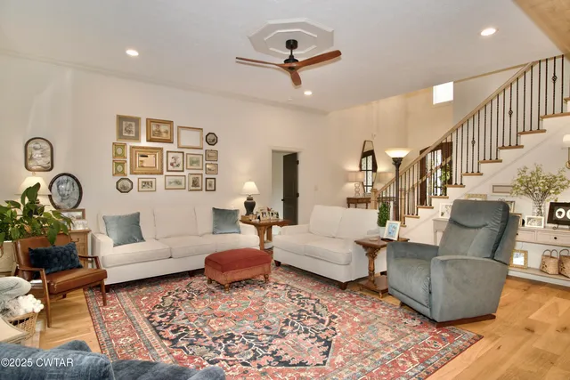 a living room with a fireplace furniture and a flat screen tv