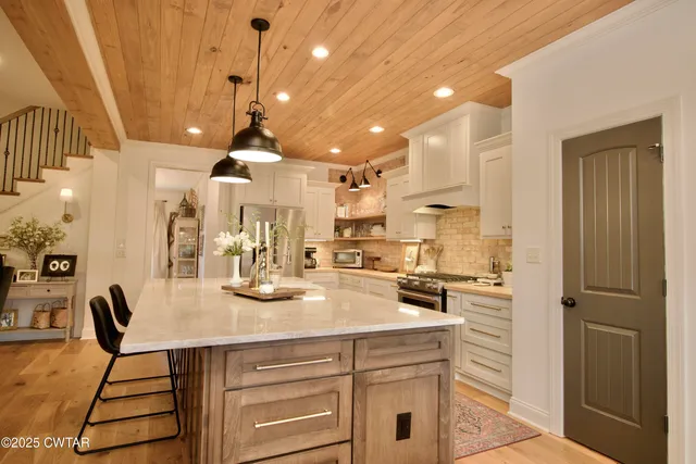 a bedroom with a bed and a potted plant