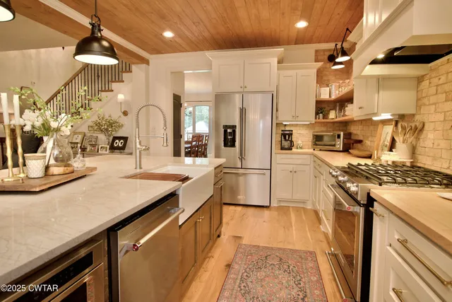 a bathroom with a double vanity sink mirror and shower