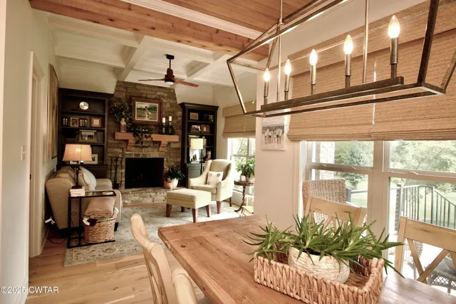 a view of a dining room with furniture large windows and wooden floor