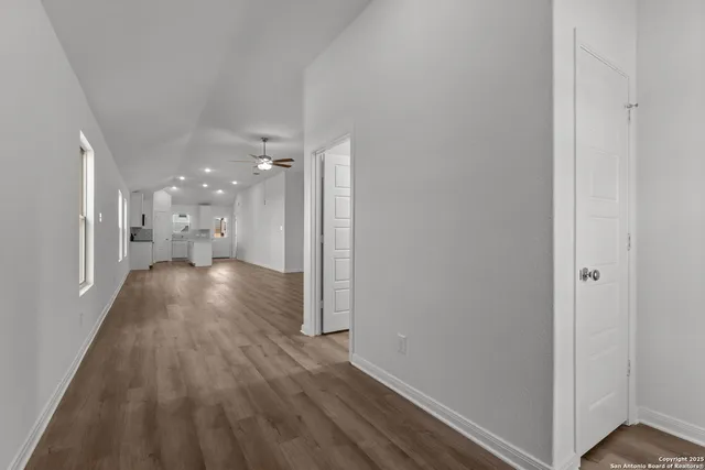 a view of a hallway with wooden floor