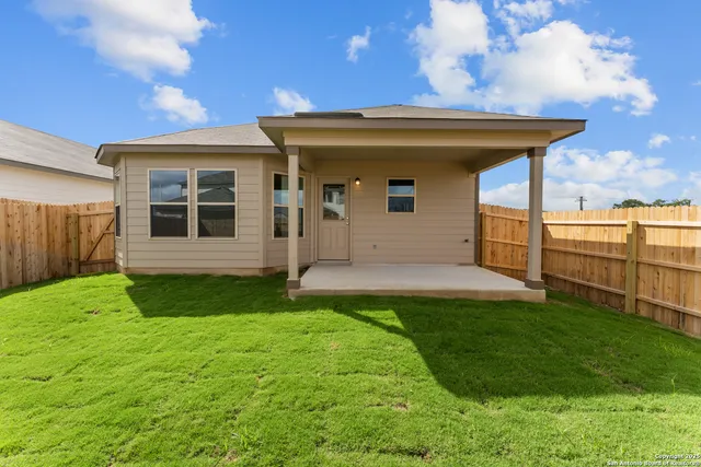 a view of a house with yard and sitting area