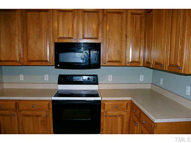 1432 Harvey Johnson Road Raleigh, NC 27603 - Photo 8 of 25 a kitchen with a cabinets and appliances