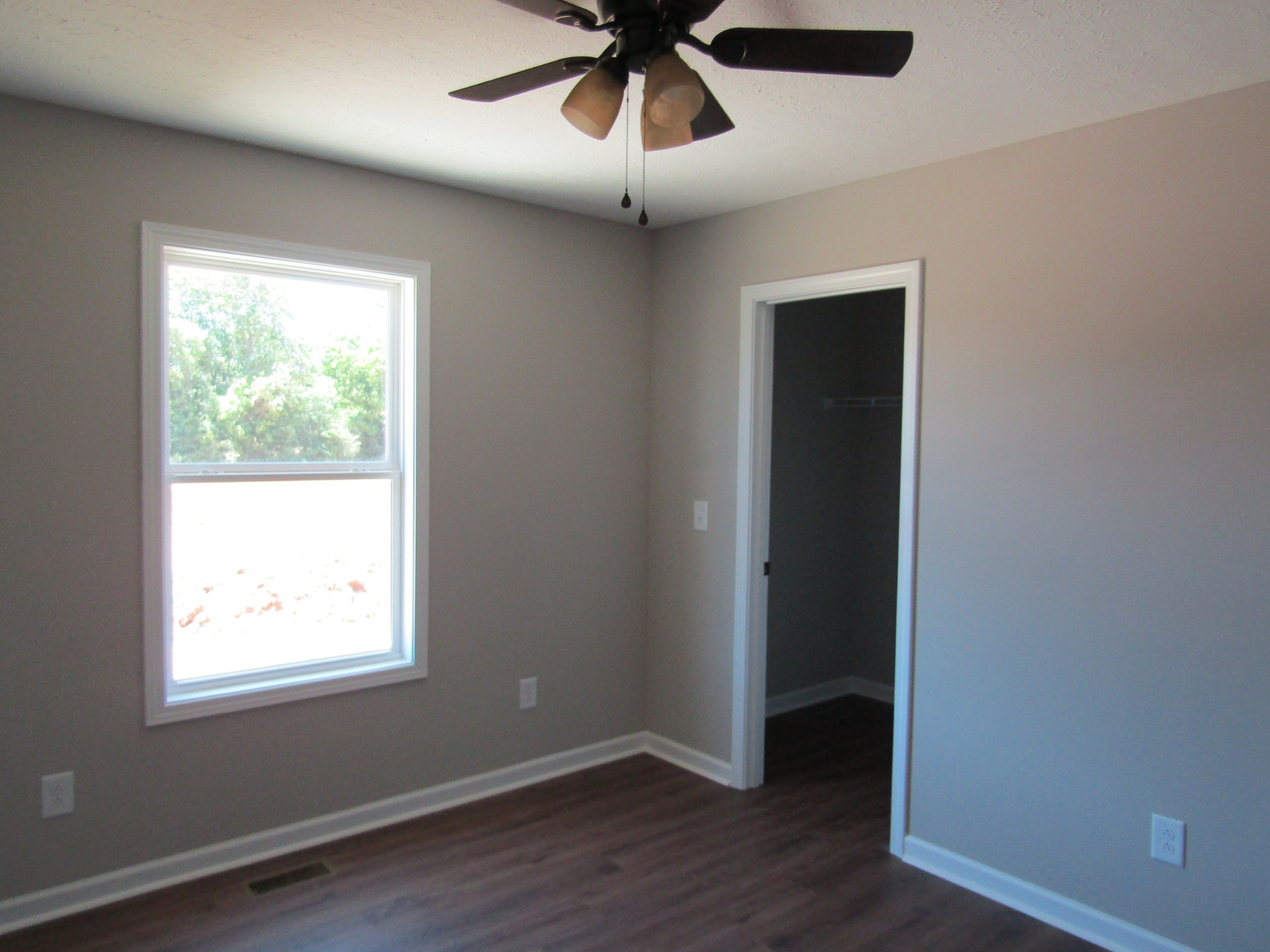 460 Crescent Factory Road Lawrenceburg, TN 38464 - Photo 10 of 13 a view of an empty room with wooden floor and a window