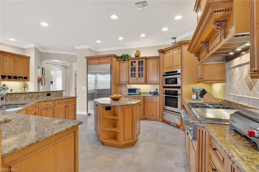 1964 Rialto Way Alva, FL 33920 - Photo 14 of 50 a kitchen with stainless steel appliances granite countertop sink stove top oven and cabinets