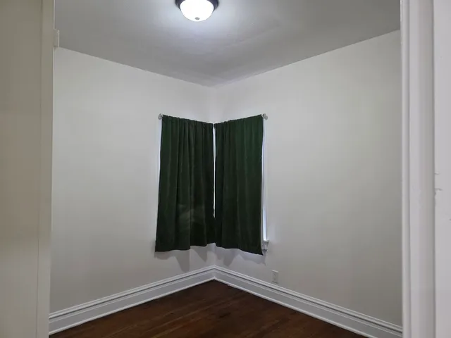 an empty room with wooden floor