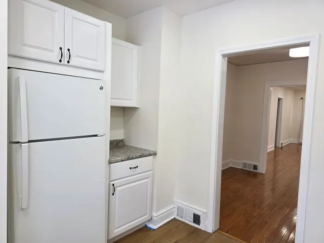 a white refrigerator freezer and a stove sitting inside of a kitchen
