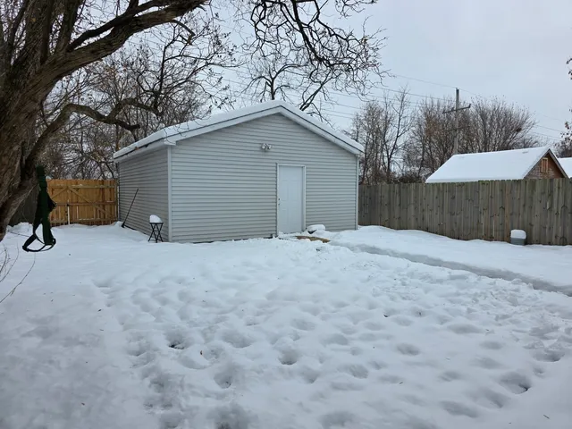 a view of a house with a snow yard and covered with snow