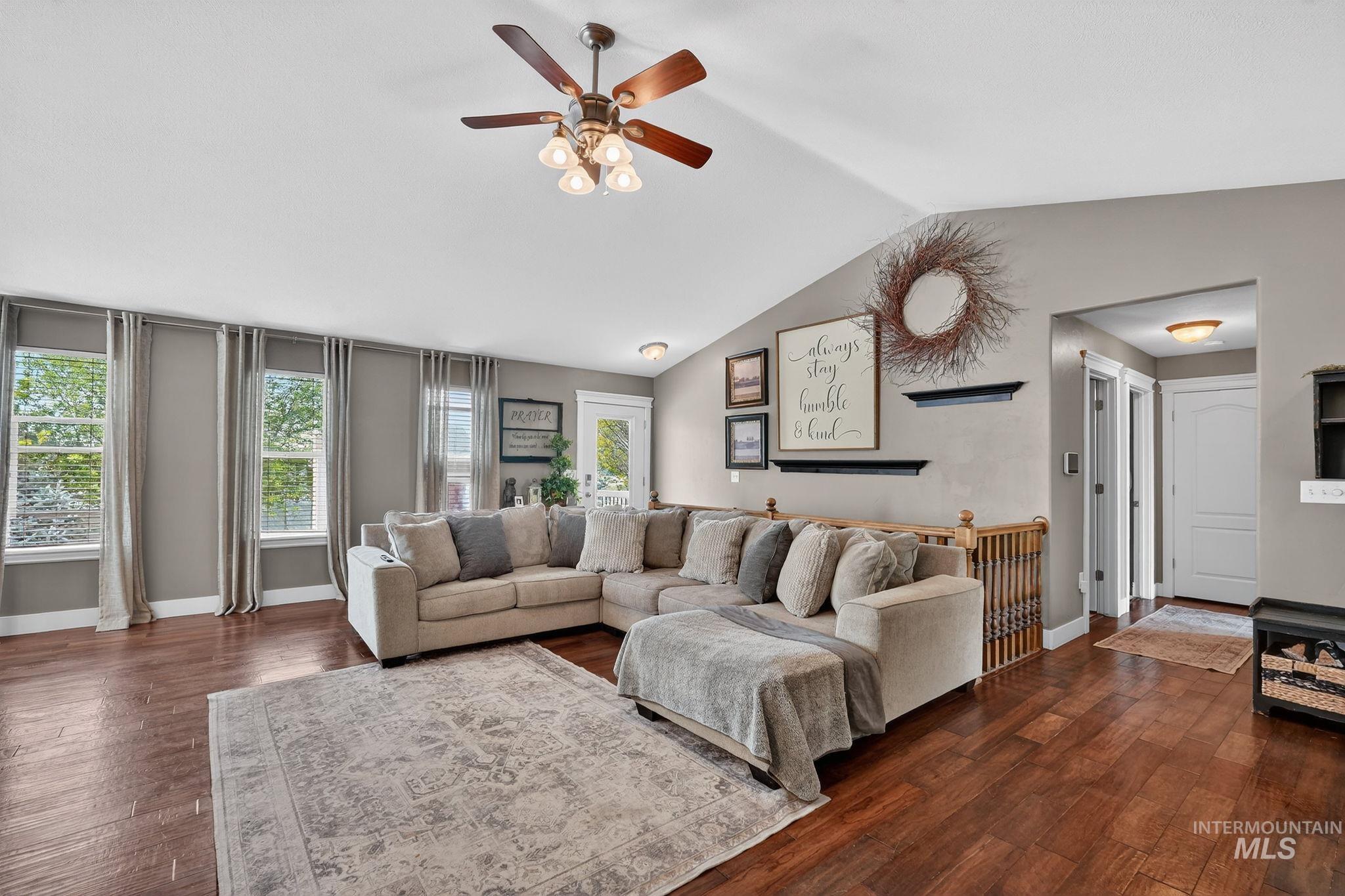 880 Redman Street Chubbuck, ID 83202 - Photo 10 of 39 Living room featuring dark wood finished floors and ceiling fan