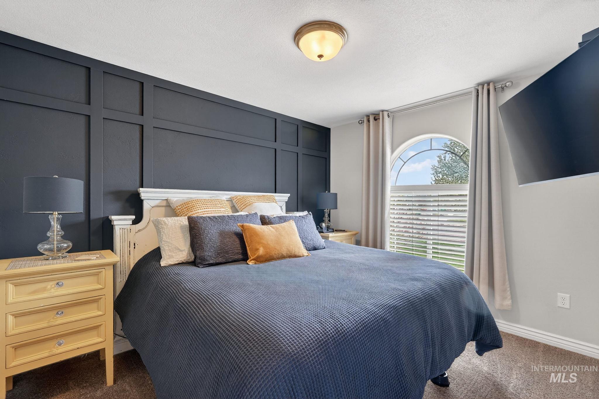 880 Redman Street Chubbuck, ID 83202 - Photo 14 of 39 Carpeted bedroom with a decorative wall