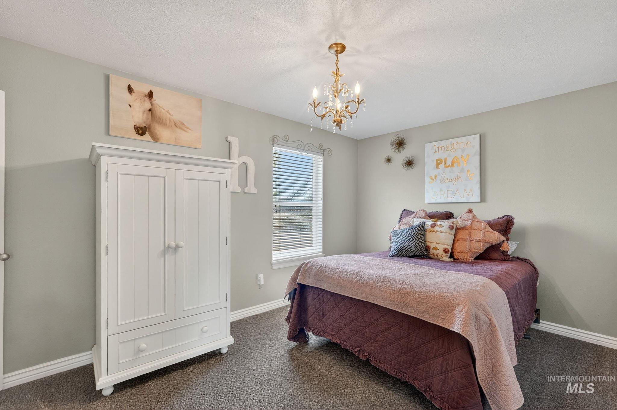880 Redman Street Chubbuck, ID 83202 - Photo 18 of 39 Bedroom with suspended lighting and dark colored carpet
