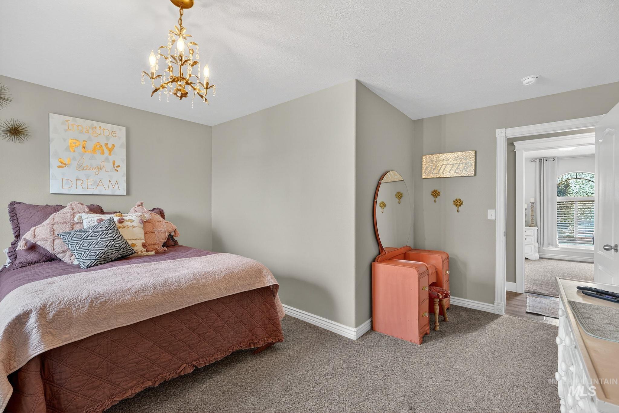 880 Redman Street Chubbuck, ID 83202 - Photo 19 of 39 Carpeted bedroom featuring baseboards and suspended lighting